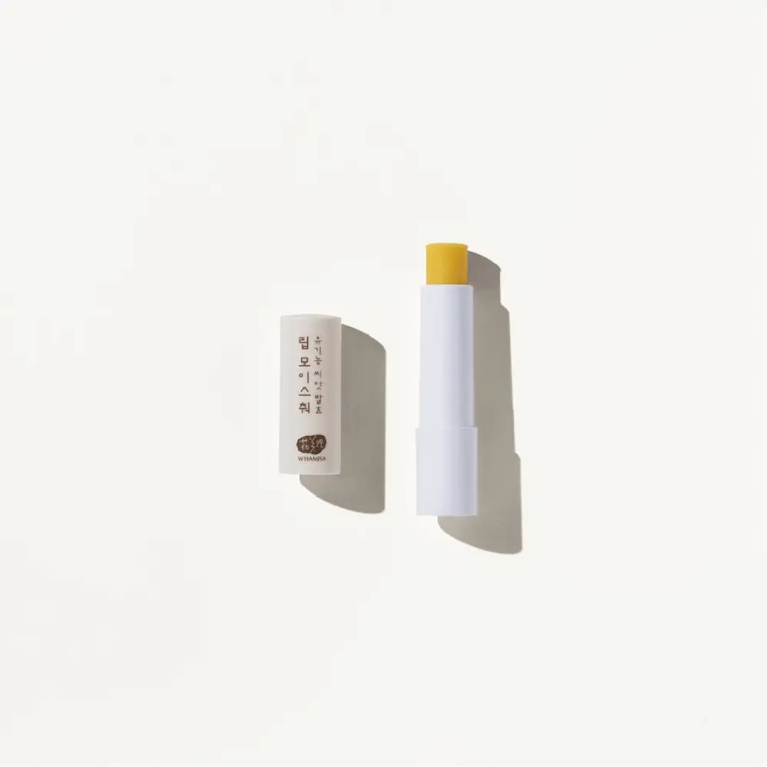 Stick of Whamisa Organic Seeds Lip Balm over a white background
